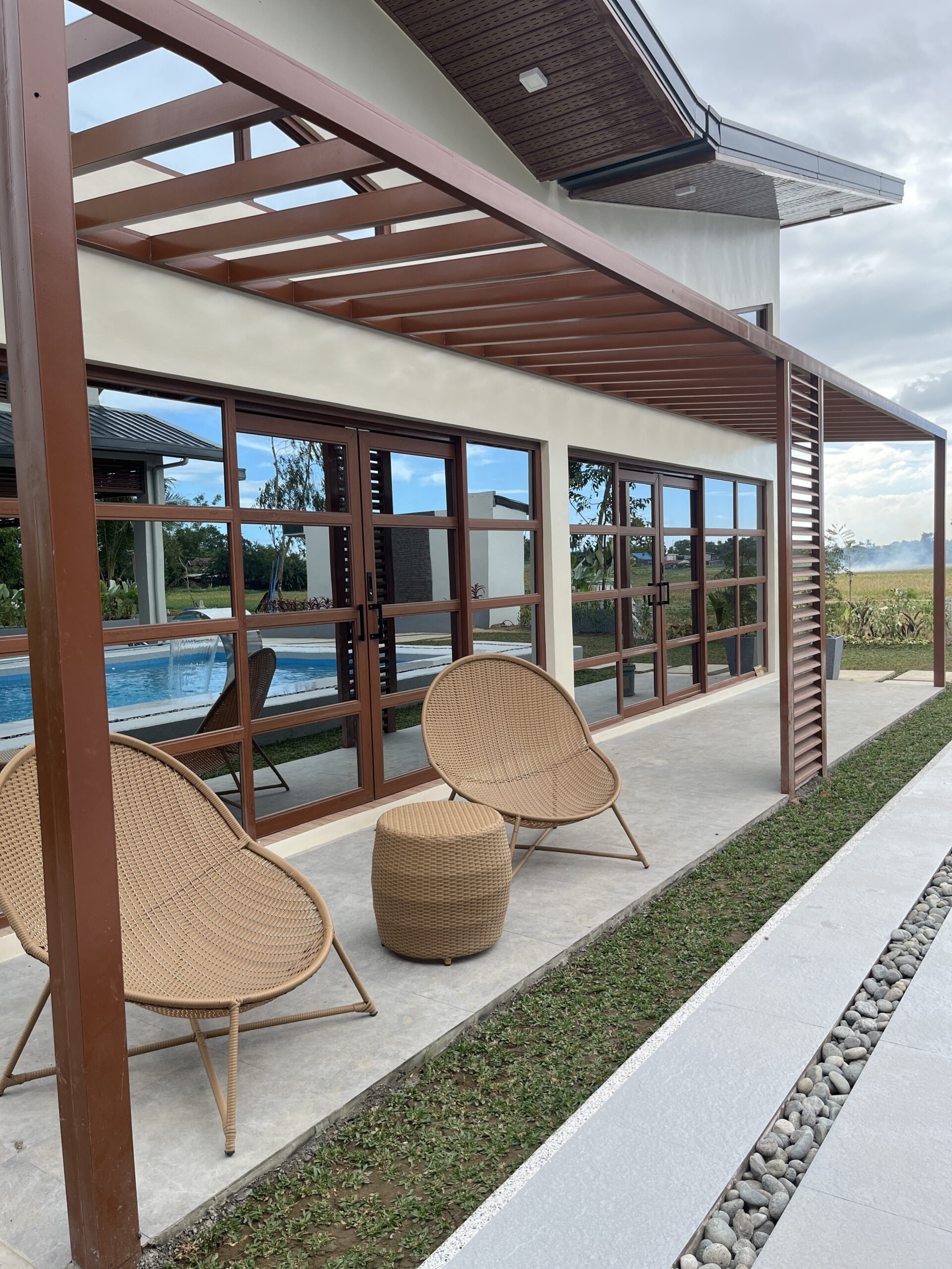 Poolside lounge chairs with rice-field view
